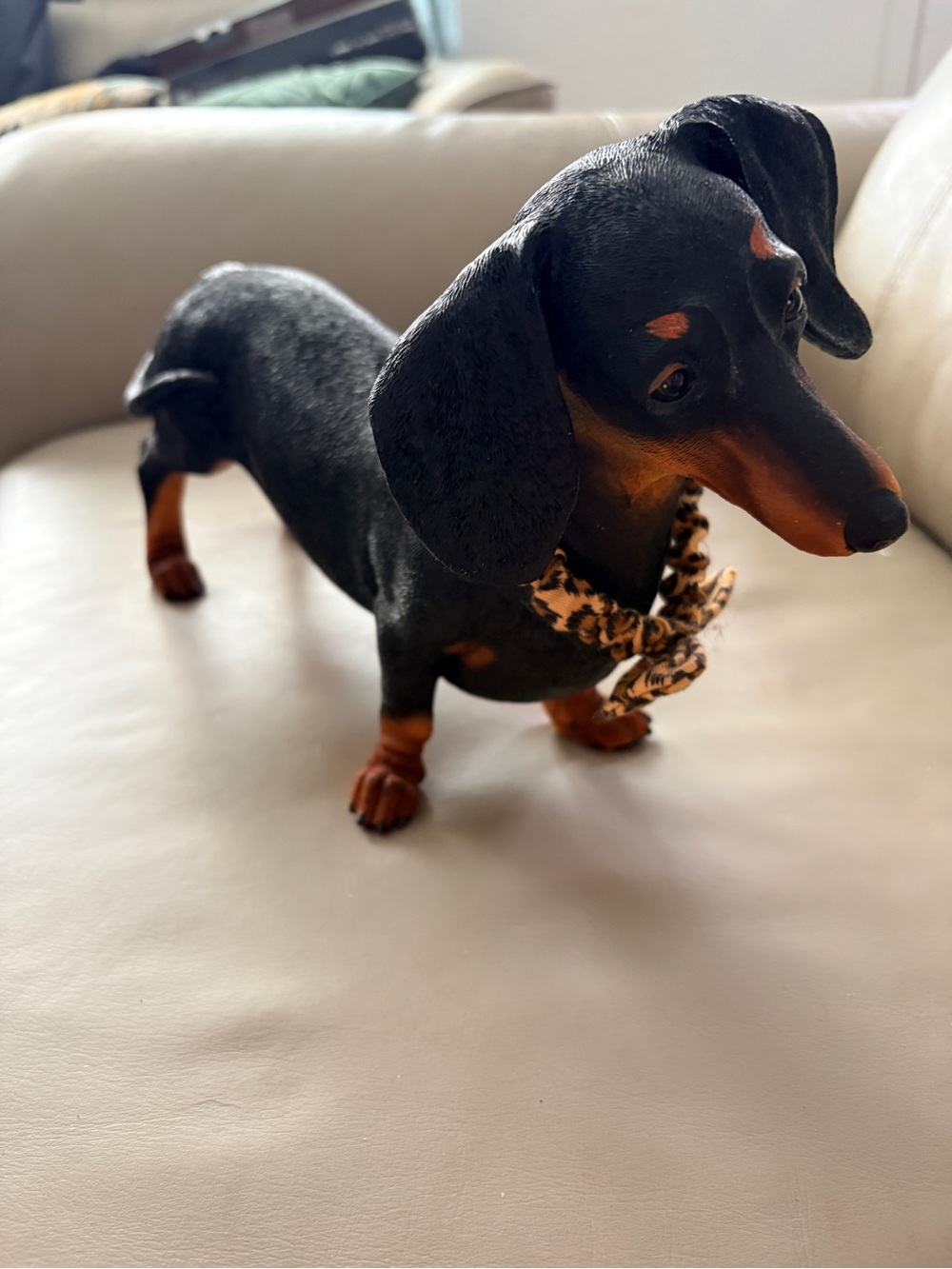 Black and Brown Dachshund Figurine with Leopard Bow